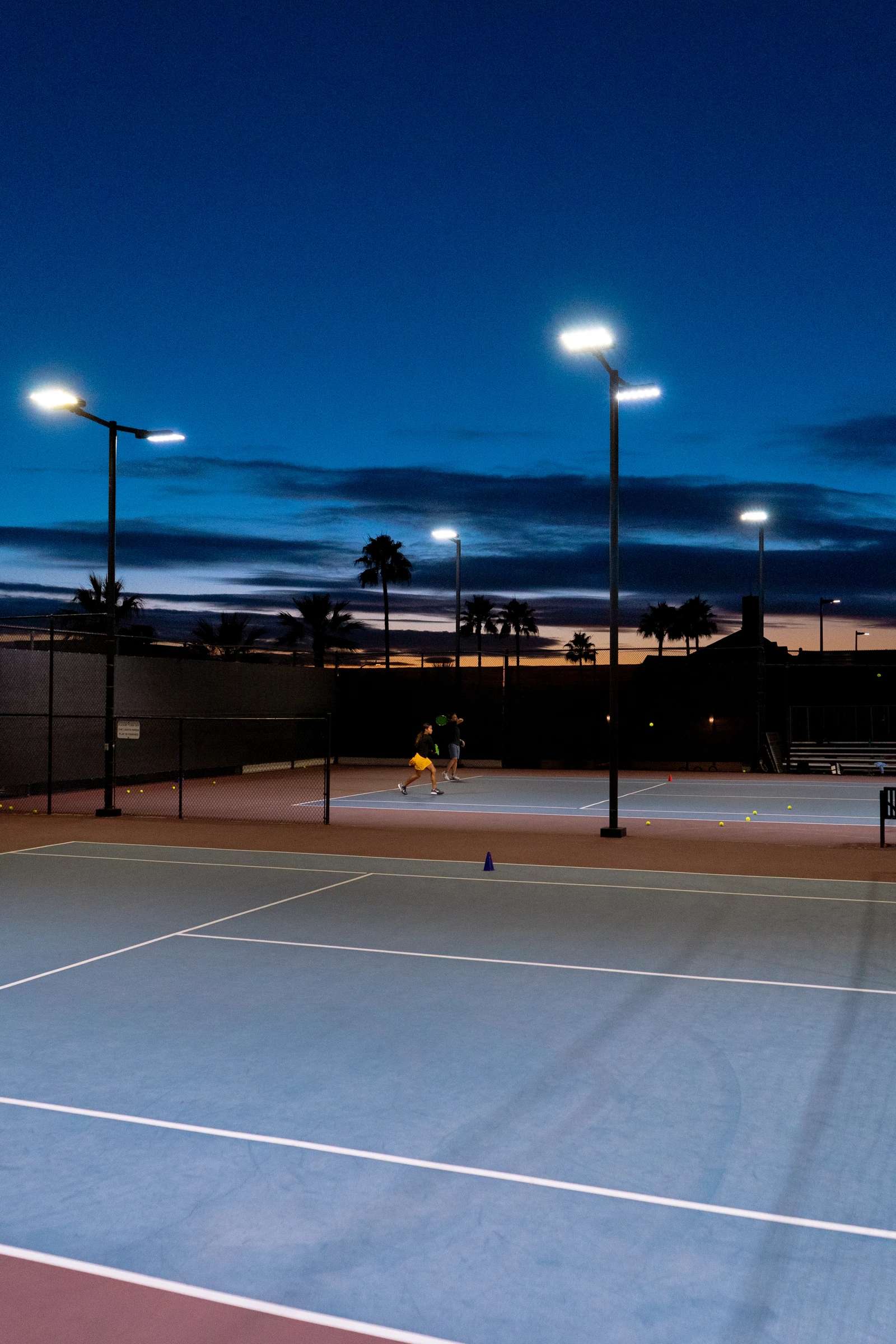 Outdoor tennis courts at night at Laguna Beach Tennis Academy