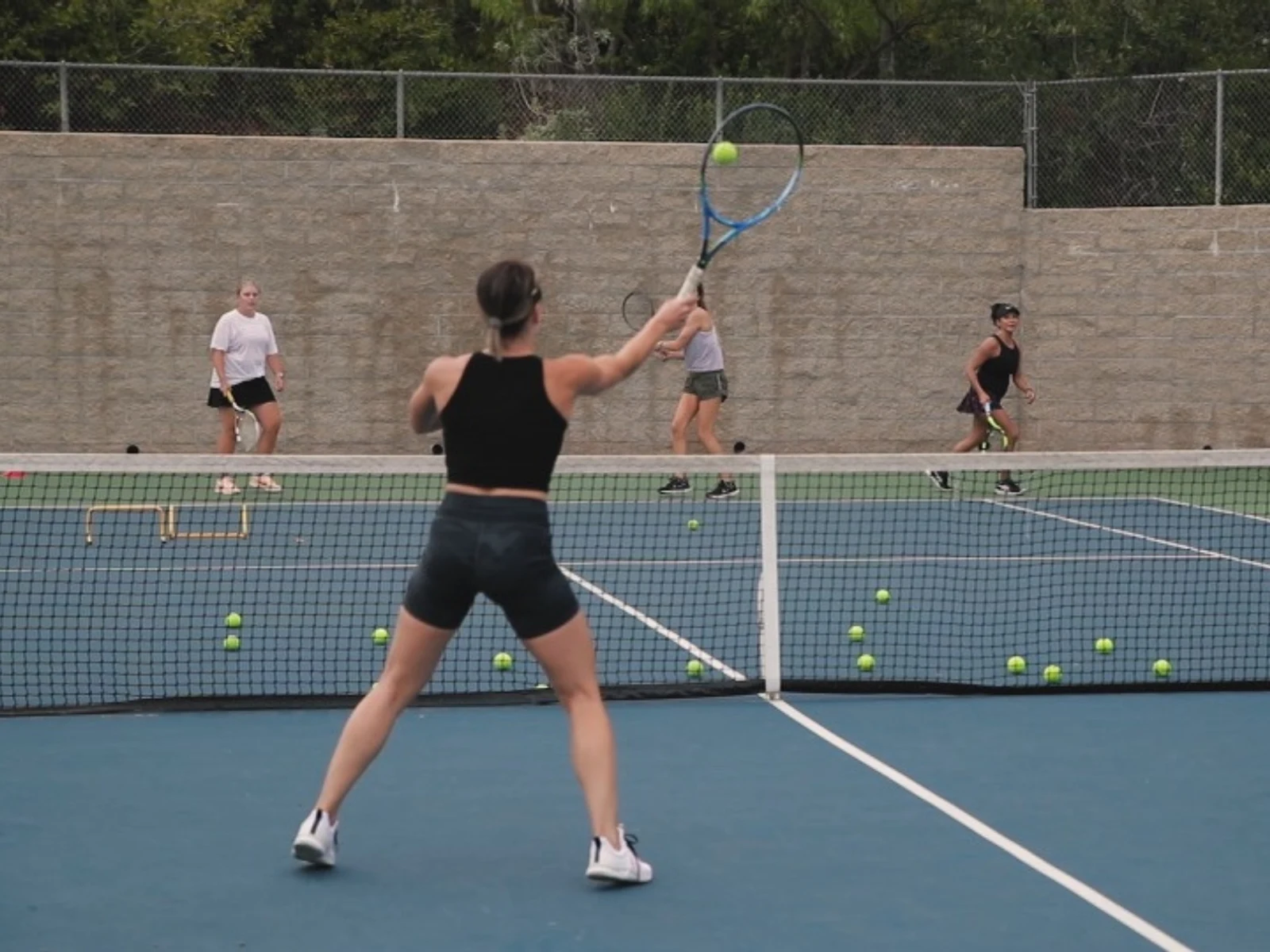 Intermediate clinic — players in structured drills on a blue court