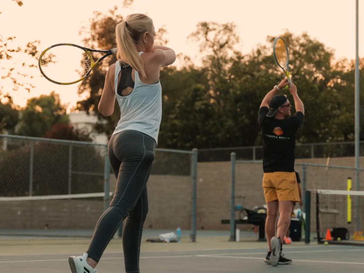 Adult beginner group practicing rally drills on Laguna courts