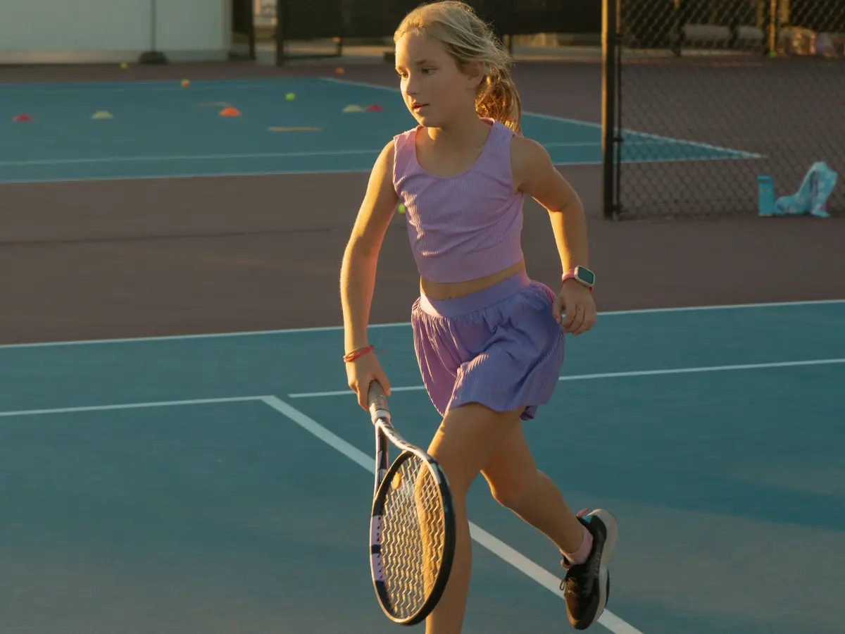 Young tennis players learning forehand technique during junior development class