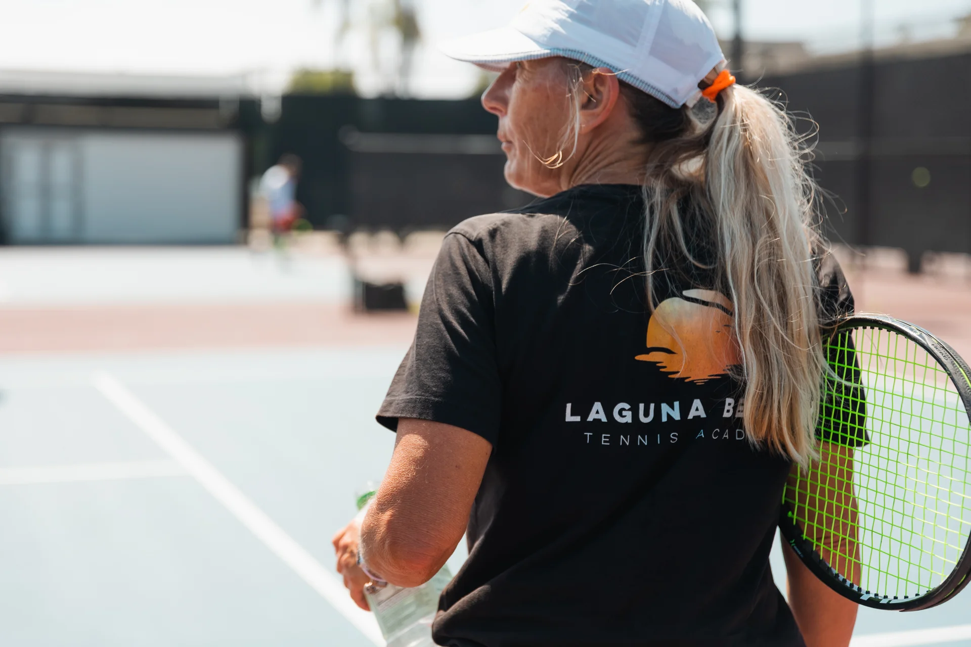An LBTA player walking off court with her racquet over her shoulder
