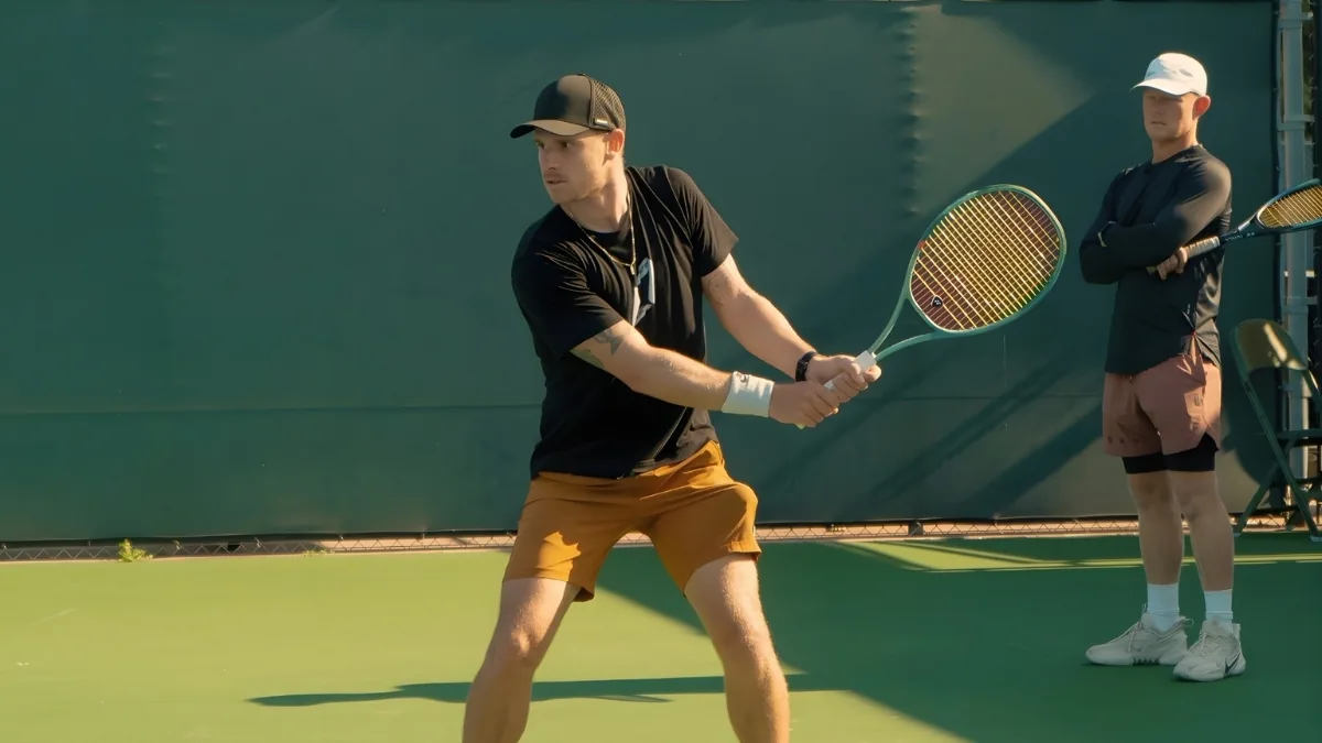 Karuê Sell hitting a two-handed backhand during training