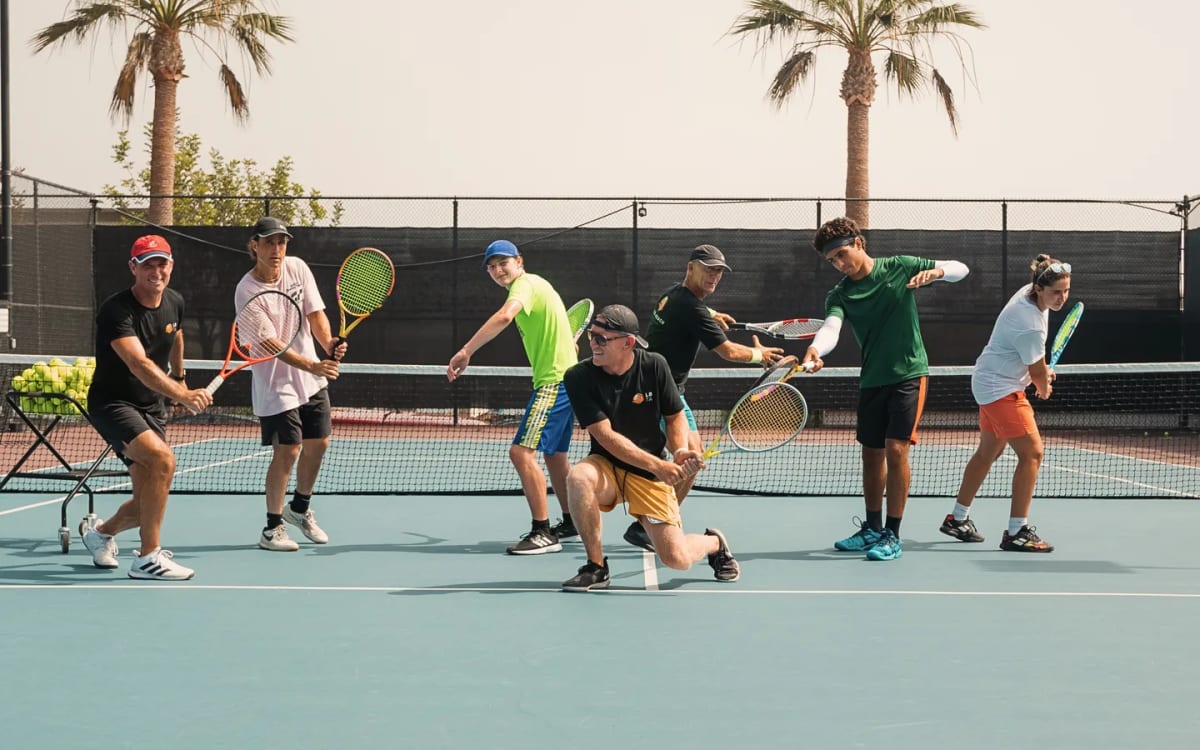 Players of every age in ready position across the court