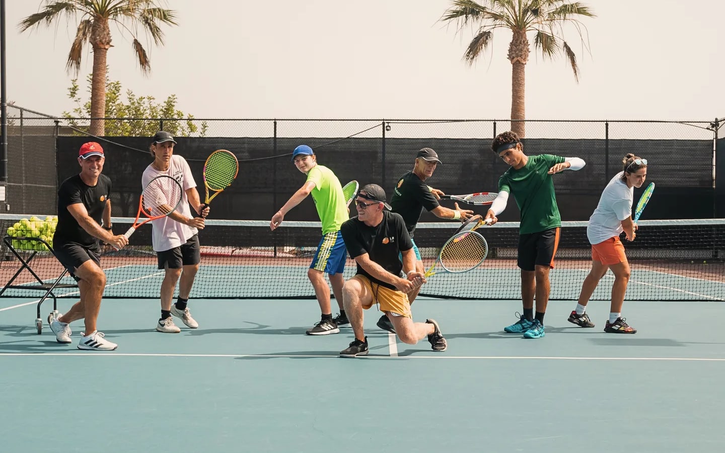 Players of every age in ready position across the court