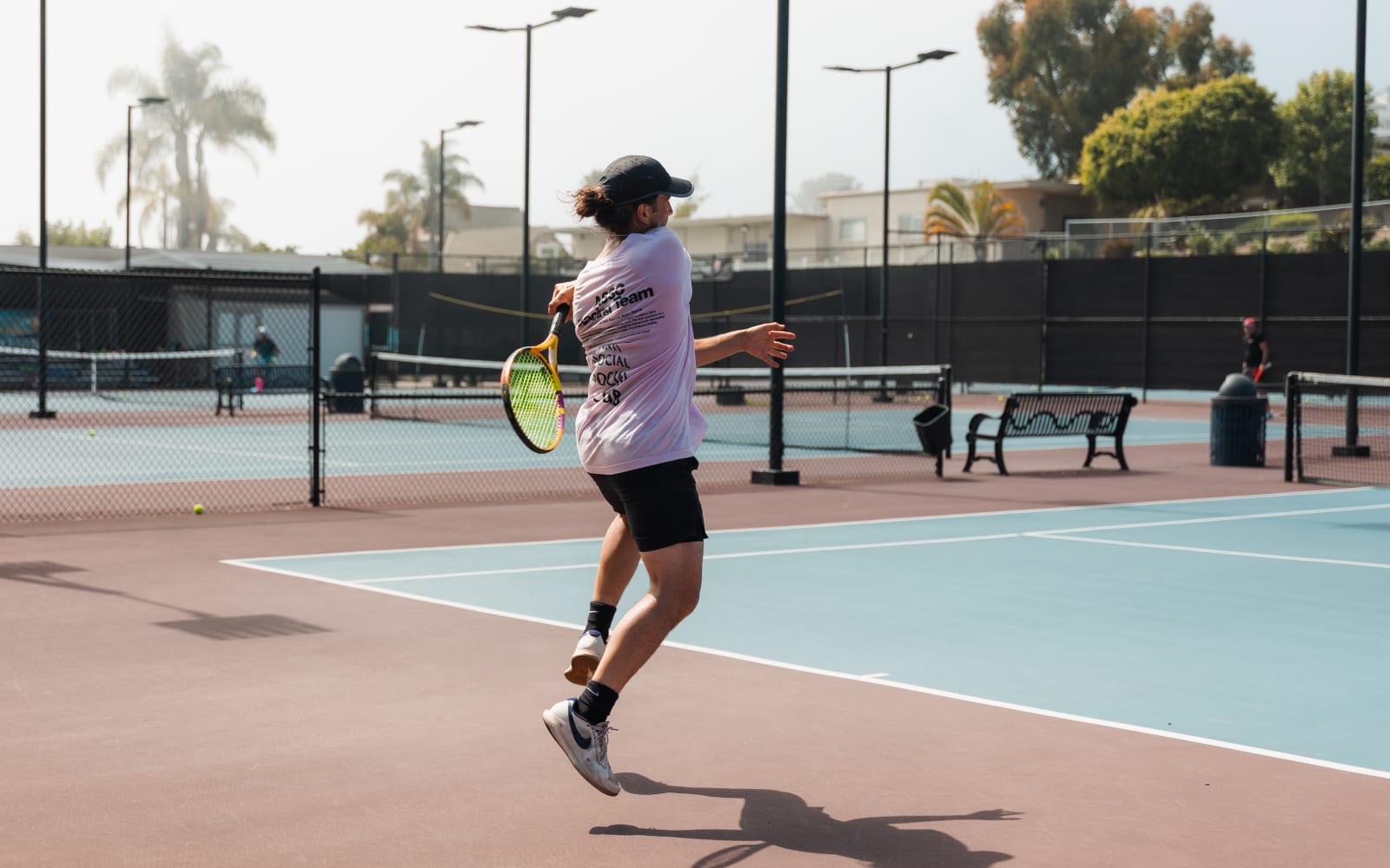 A player airborne through a forehand during a continuous drill