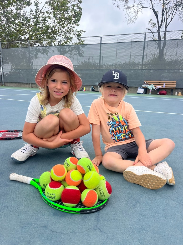 Campers practicing tennis technique and rally skills