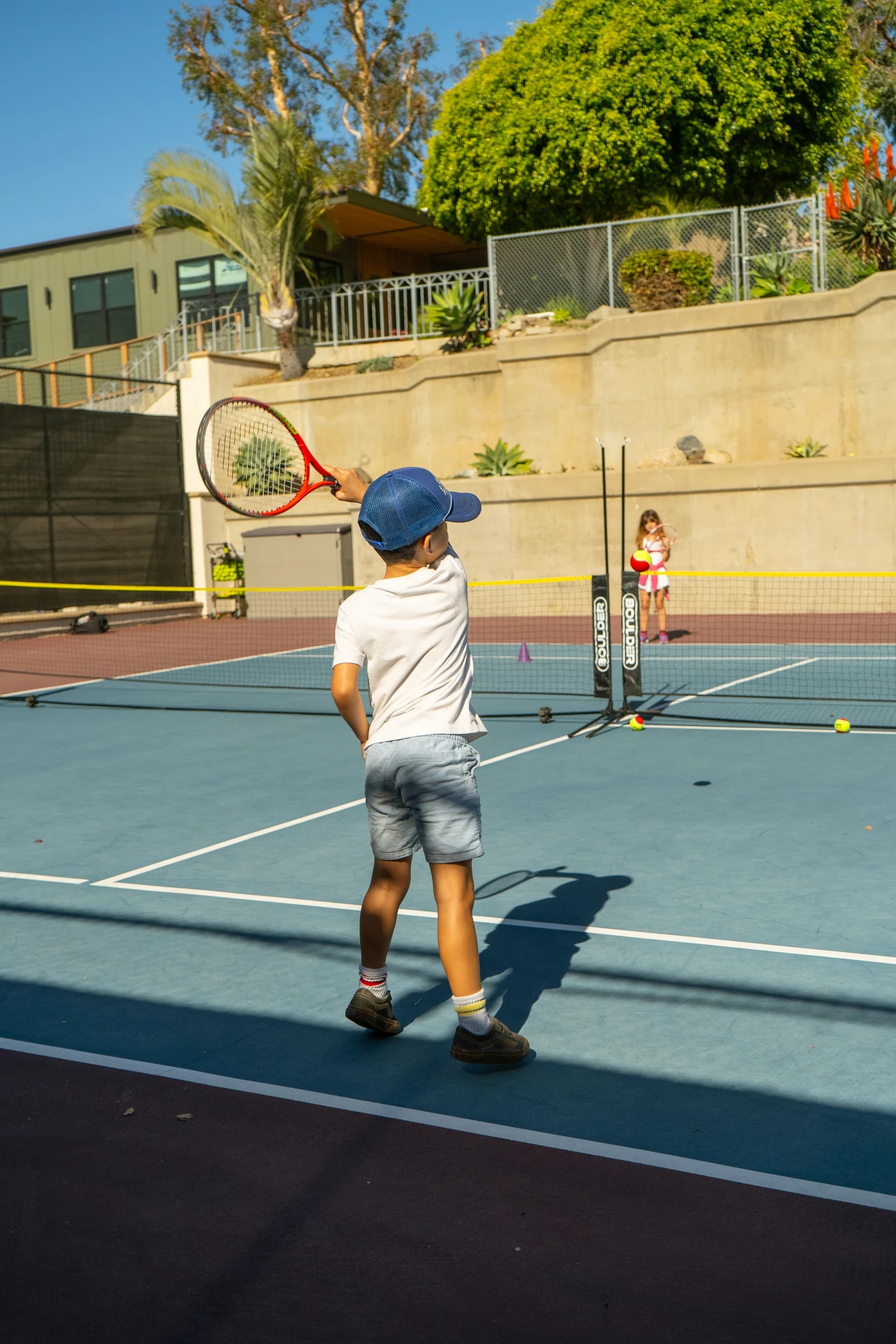 Junior player practicing forehand swing on Moulton Meadows court
