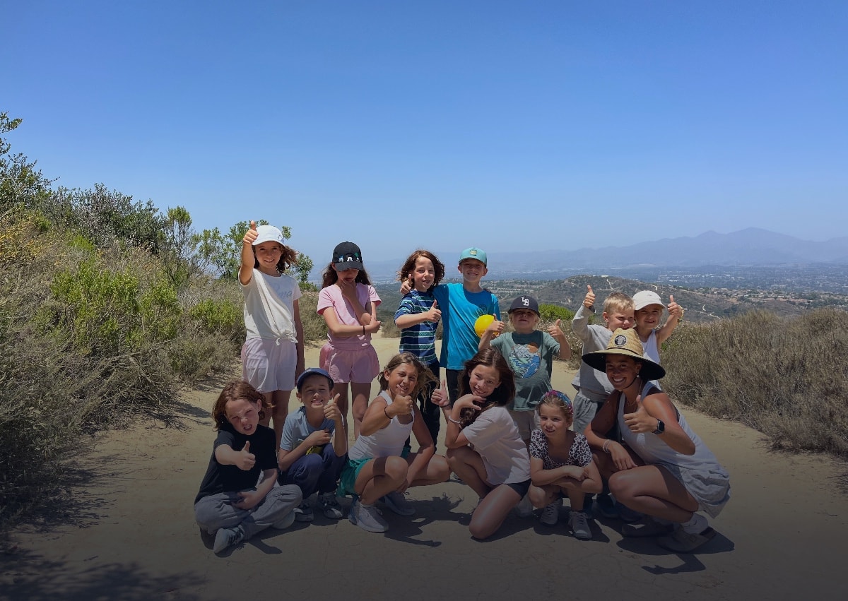 Coach leading campers through on-court movement and stroke drills