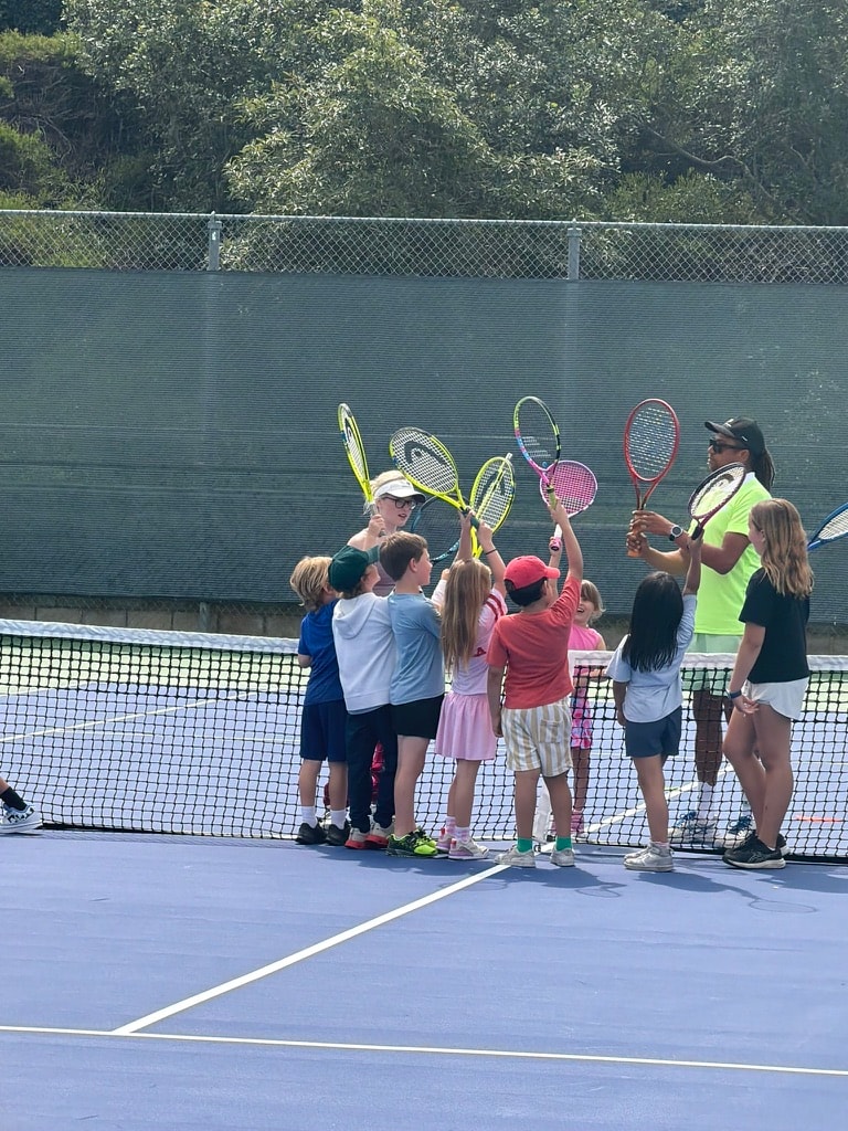 Coach guiding campers through match-play points and movement patterns