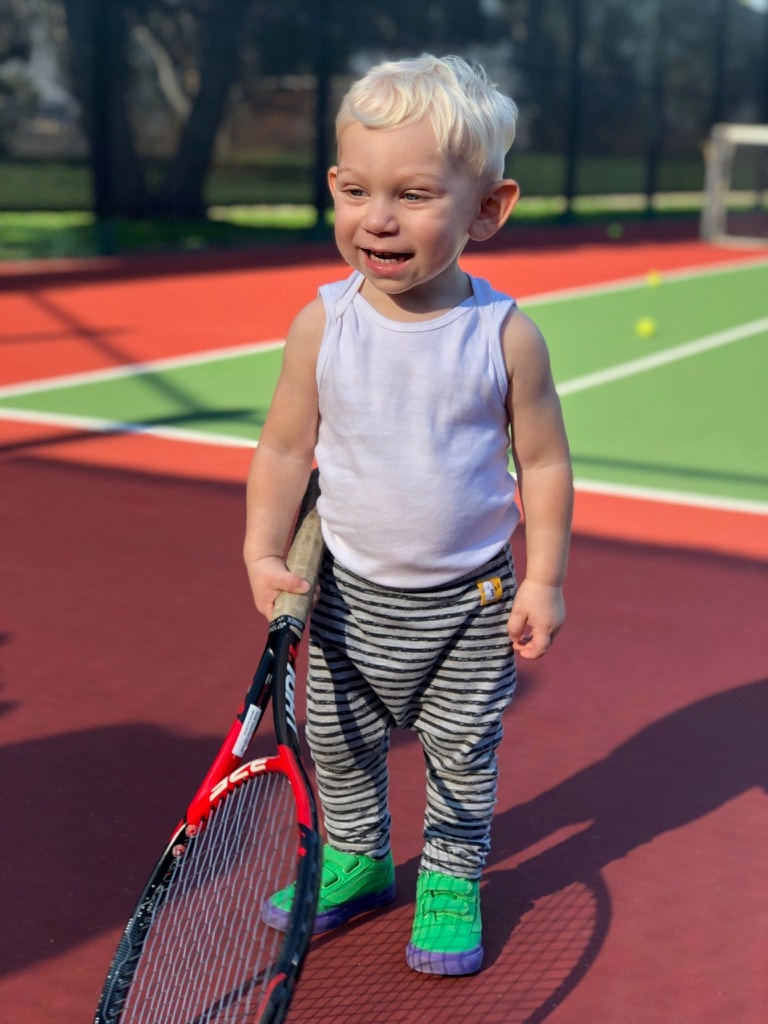 Young player smiling on court during Little Tennis Stars session
